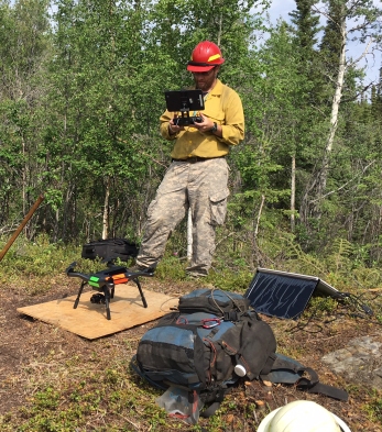 BLM Alaska Fire Service drone pilot Jason Brooks readies the quadcopter for take off before flying over the North Robertson Fire near Tok on June 10, 2017.