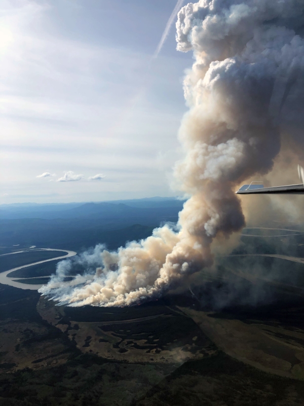 A smoke column rises from the About Mountain Fire (#193) along the east bank of the Kuskokwim River on Monday night, June 14, 2021