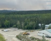 A smoke column with a forest and an equipment field near the Gerstle River.